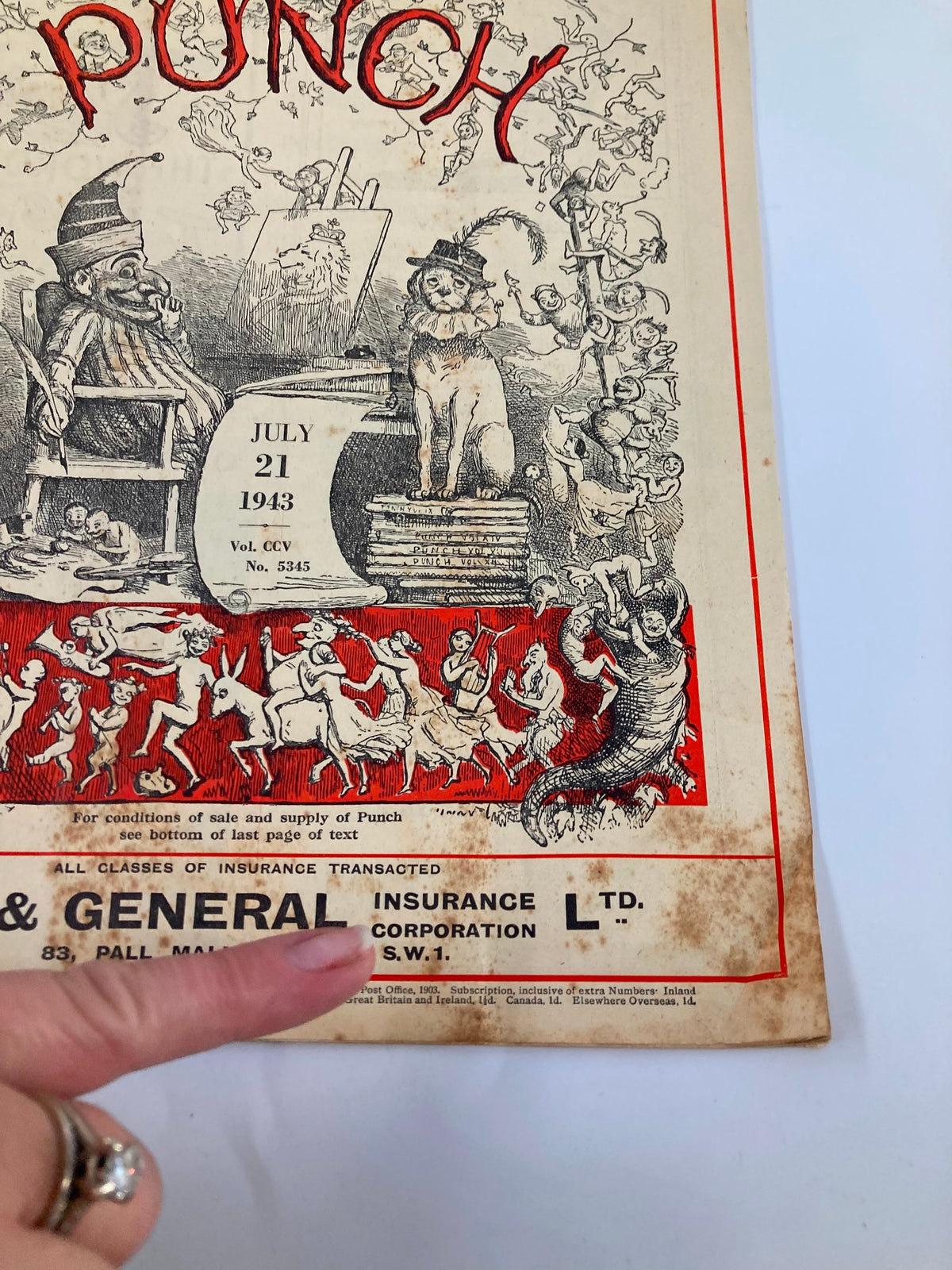 Close-up view of the VTG Punch Magazine cover dated July 21, 1943, highlighting details such as illustrations and the publication information along with the title 'PUNCH'.