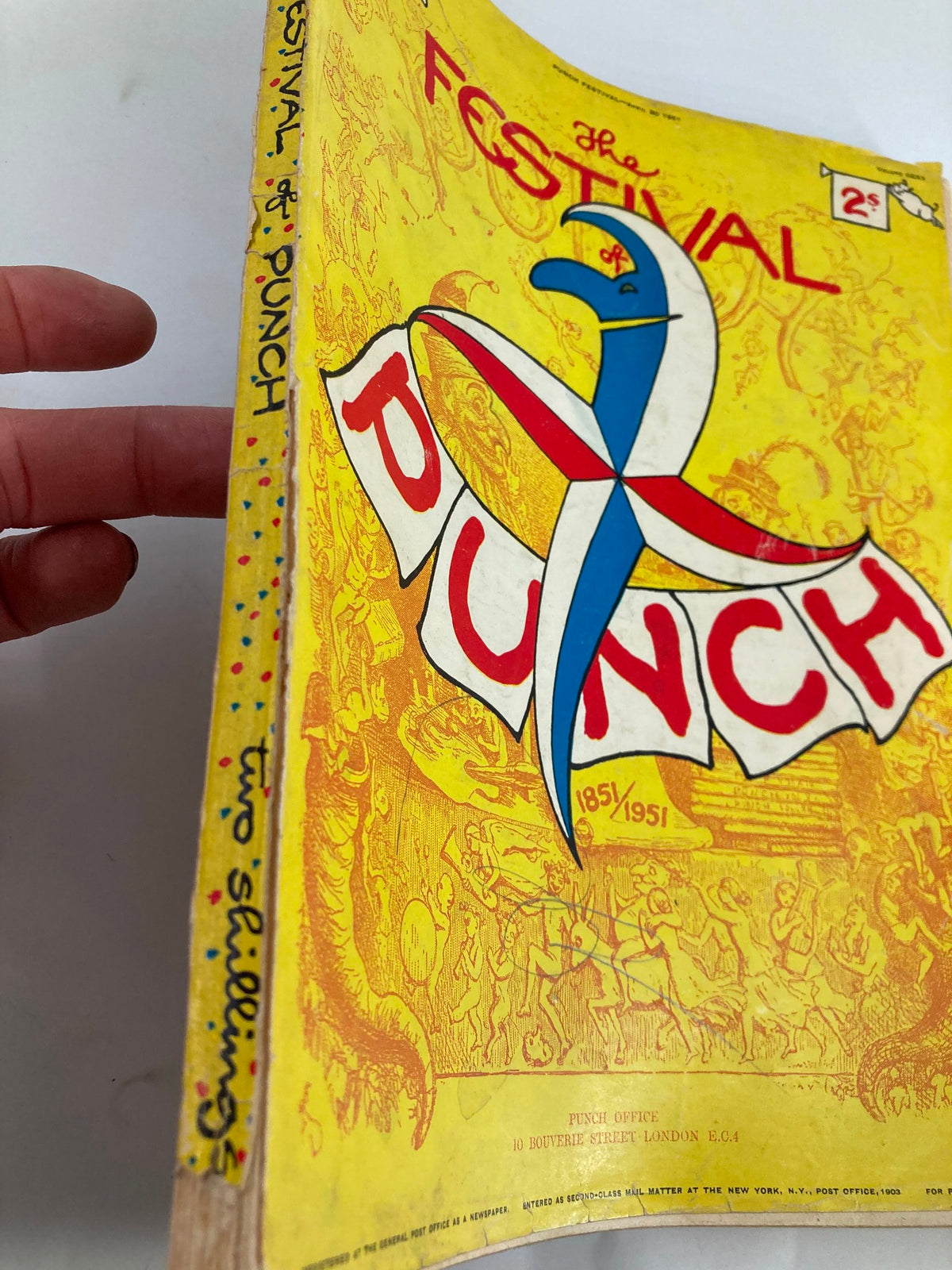Spine view of VTG Punch Magazine April 30, 1951, 'The Festival of Punch,' emphasizing vintage design with hand-written title and colorful accents representing its historical significance.