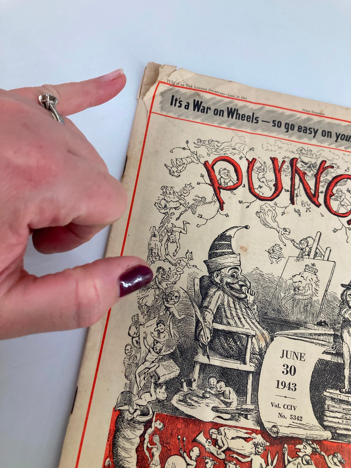 Detail of the VTG Punch Magazine June 30 1943 #5342 Vol 204 cover, showcasing a hand pointing at whimsical characters and artwork related to wartime humor.