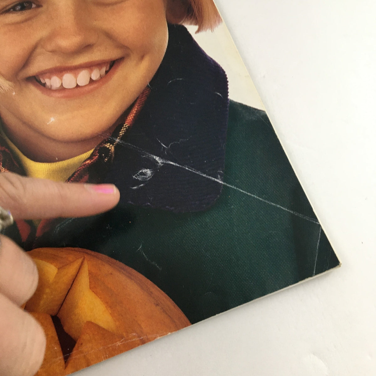 Image from American Girl Magazine September-October 1995 showcasing a smiling girl with a pumpkin, reflecting the fun and creativity of childhood activities.