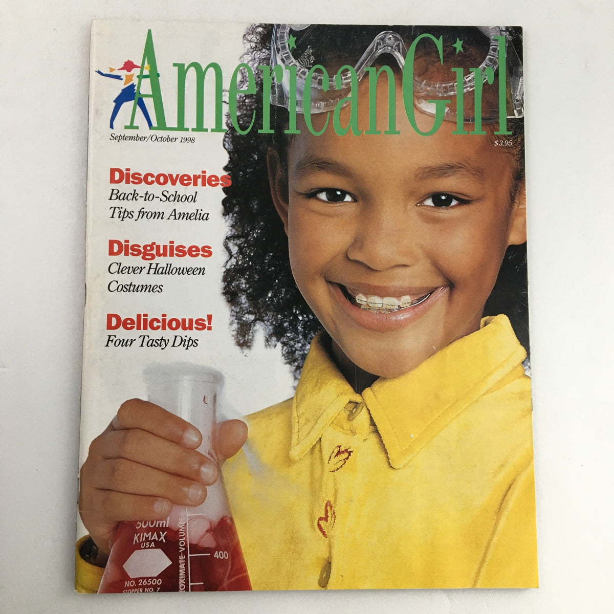 Cover of American Girl Magazine September-October 1998 featuring Back-to-School tips from Amelia, showcasing a smiling girl with braces and a bright yellow shirt, holding a beaker.