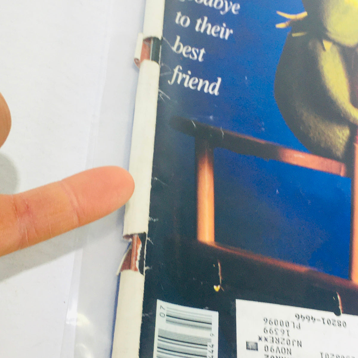 Close-up view of the edge of the vintage Life Magazine from July 1990 featuring a noticeable crease and a finger pointing at it, highlighting the magazine's condition. This issue showcases Rose Kennedy at One Hundred and Jim Henson with the Muppets.