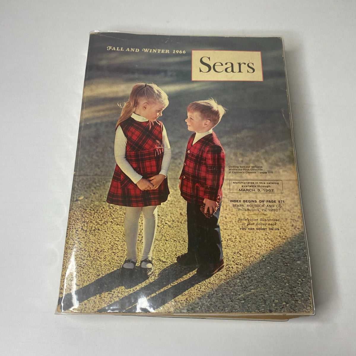 Cover of the 1966 Sears Classic Fall and Winter Catalog featuring two children in matching plaid outfits, highlighting vintage children’s fashion and merchandise.