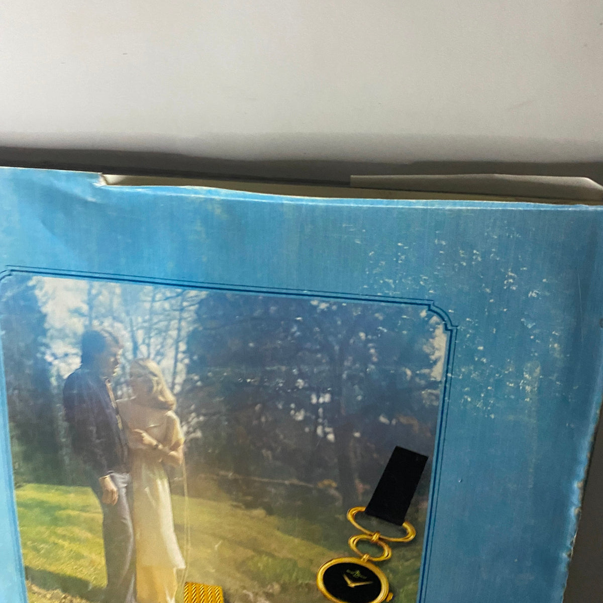 Close-up of Vogue Paris Magazine April 1978 Dayle Haddon Cover No Label with a vintage Baume & Mercier watches advertisement, highlighting the collection of elegant watches beside a romantic image of a couple in nature.