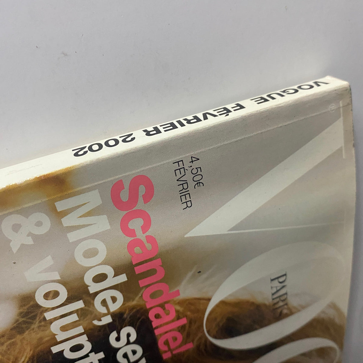 Close-up view of the spine of Vogue Paris Magazine February 2002, highlighting the publication's vintage touch.