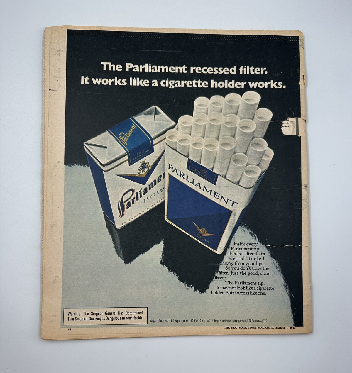 Back cover of The New York Times Magazine March 4, 1973, advertising Parliament cigarettes with a visual of cigarette packs and a warning about health risks. This reflects advertising trends of the era.