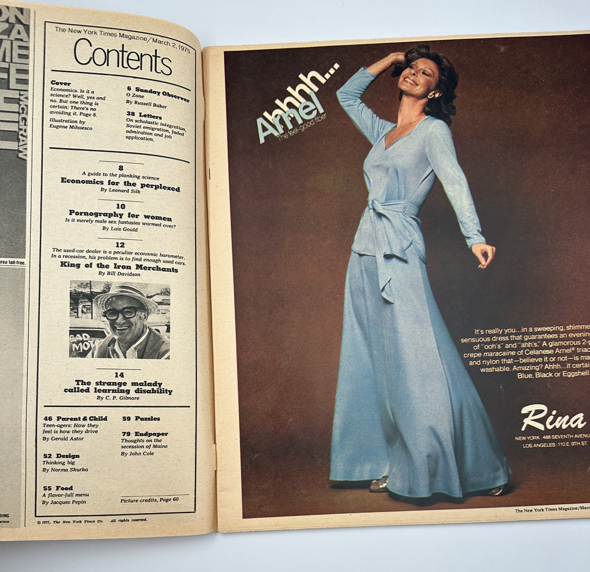 Interior page of The New York Times Magazine, March 2, 1975, displaying the Table of Contents alongside a fashion advertisement featuring a model in a blue dress, with enticing text about the magazine's report on 'Economics for the Perplexed'.