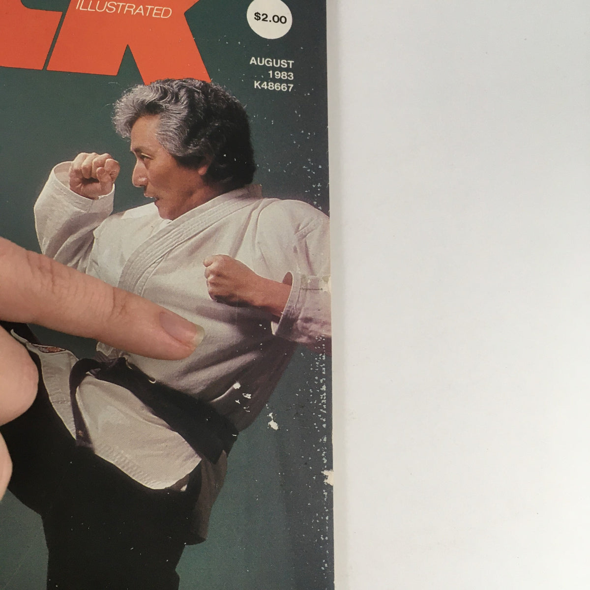 Close-up of the cover of Kick Illustrated Magazine August 1983 Vol 4 #8, featuring a martial artist demonstrating a kick.