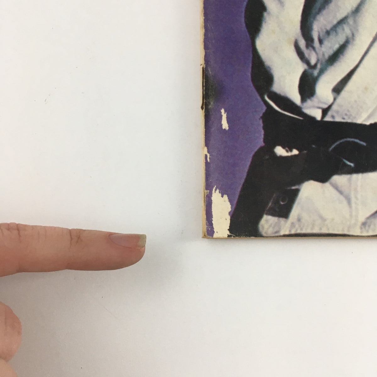 Close-up of the edge of Black Belt Magazine March 1971 Vol 9 #3, showcasing minor wear and tear typical for its vintage age.
