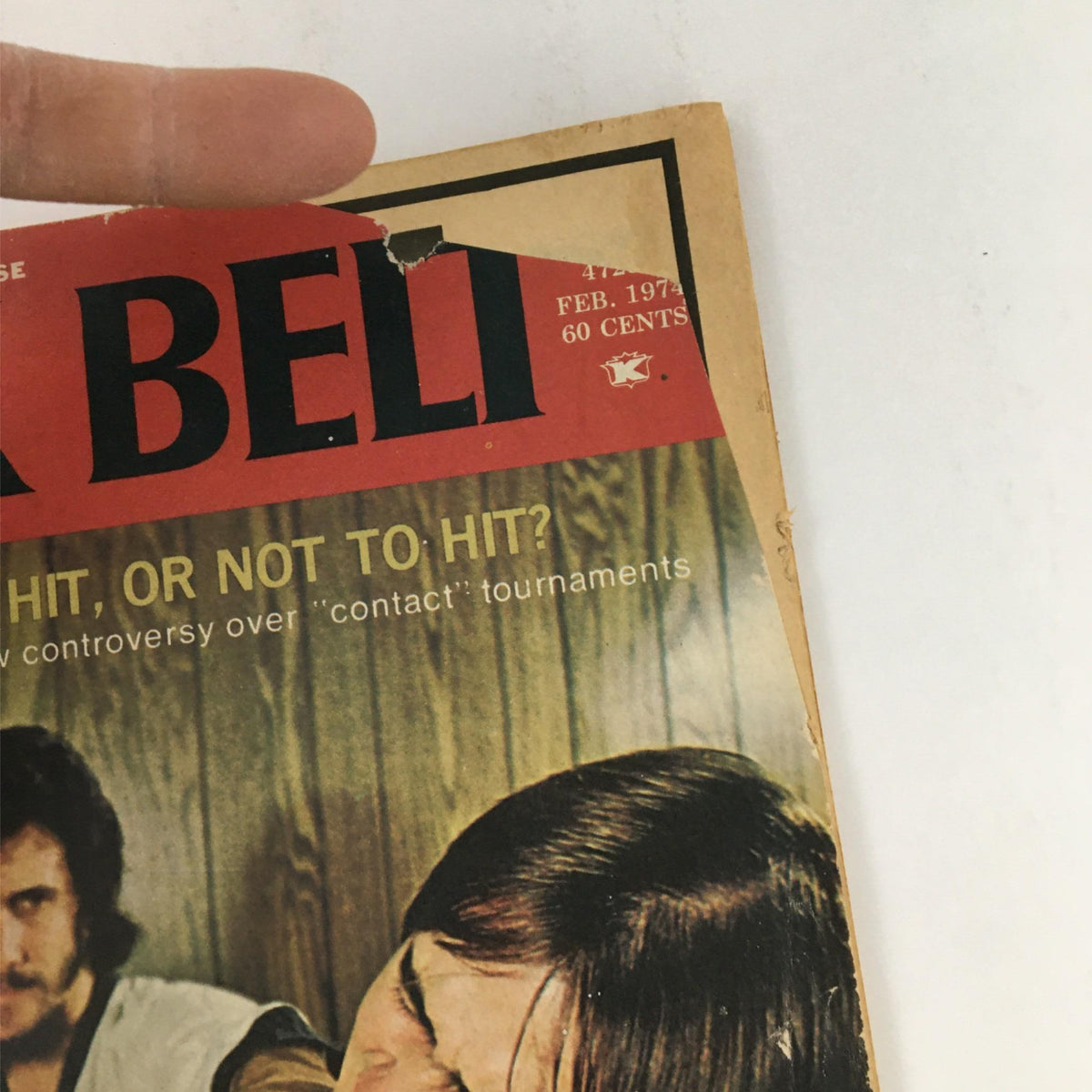Cover of Black Belt Magazine February 1974 featuring Joe Corley and Luis Tasuke Watanabe, highlighting the debate on contact tournaments with visible wear and tear.