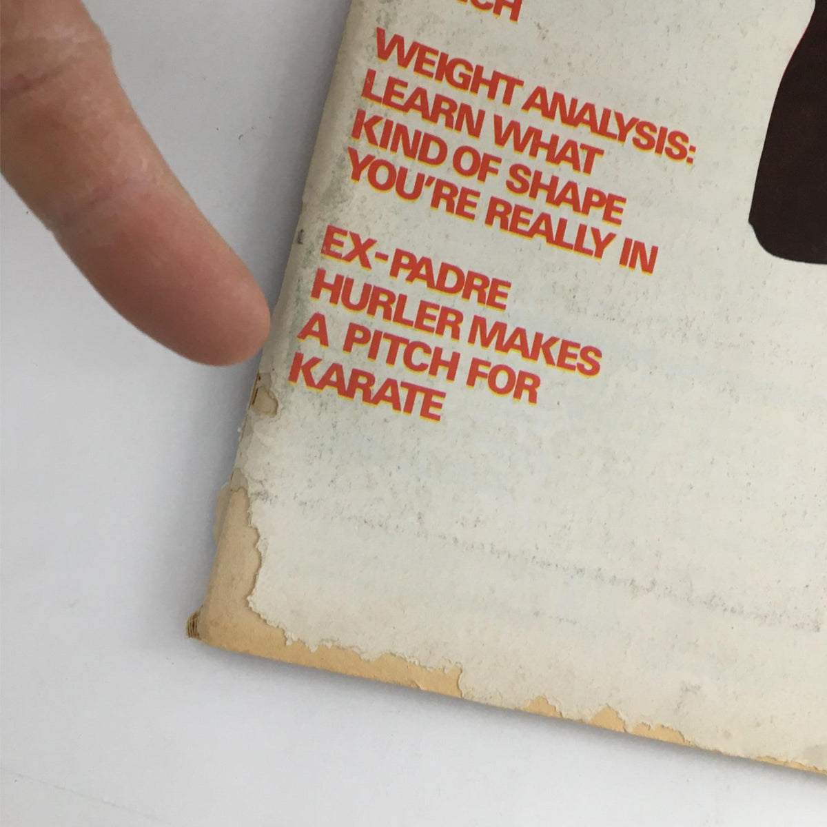 Close-up of back cover corner of Karate Illustrated Magazine January 1976, showcasing wear and promotional text related to karate.