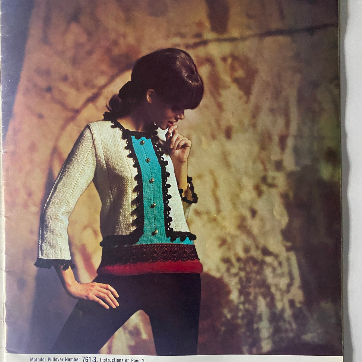 Model showcasing the Matador Pullover from the 1966 Columbia Minerva Bravo Mexico Knits Pattern Book, featuring a colorful design with buttons and ruffles.