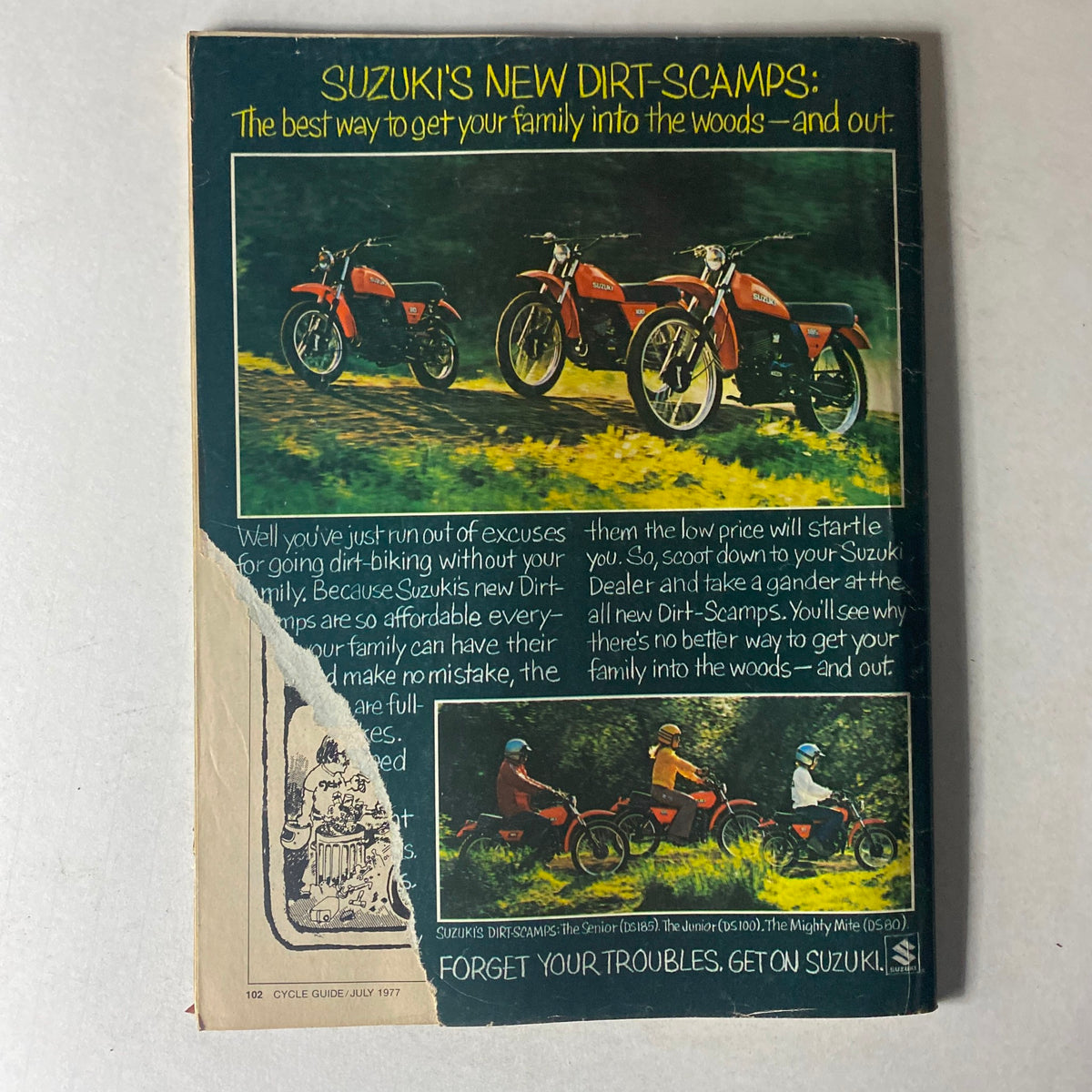 Back cover of Cycle Guide Magazine July 1977, advertising Suzuki's new Dirt-Scamps, ideal for family biking adventures.