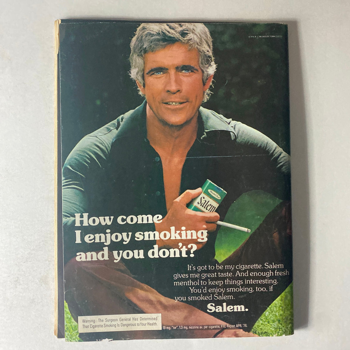 Back cover of Cycle World Magazine November 1976 featuring a Salem cigarette advertisement with a man promoting smoking.