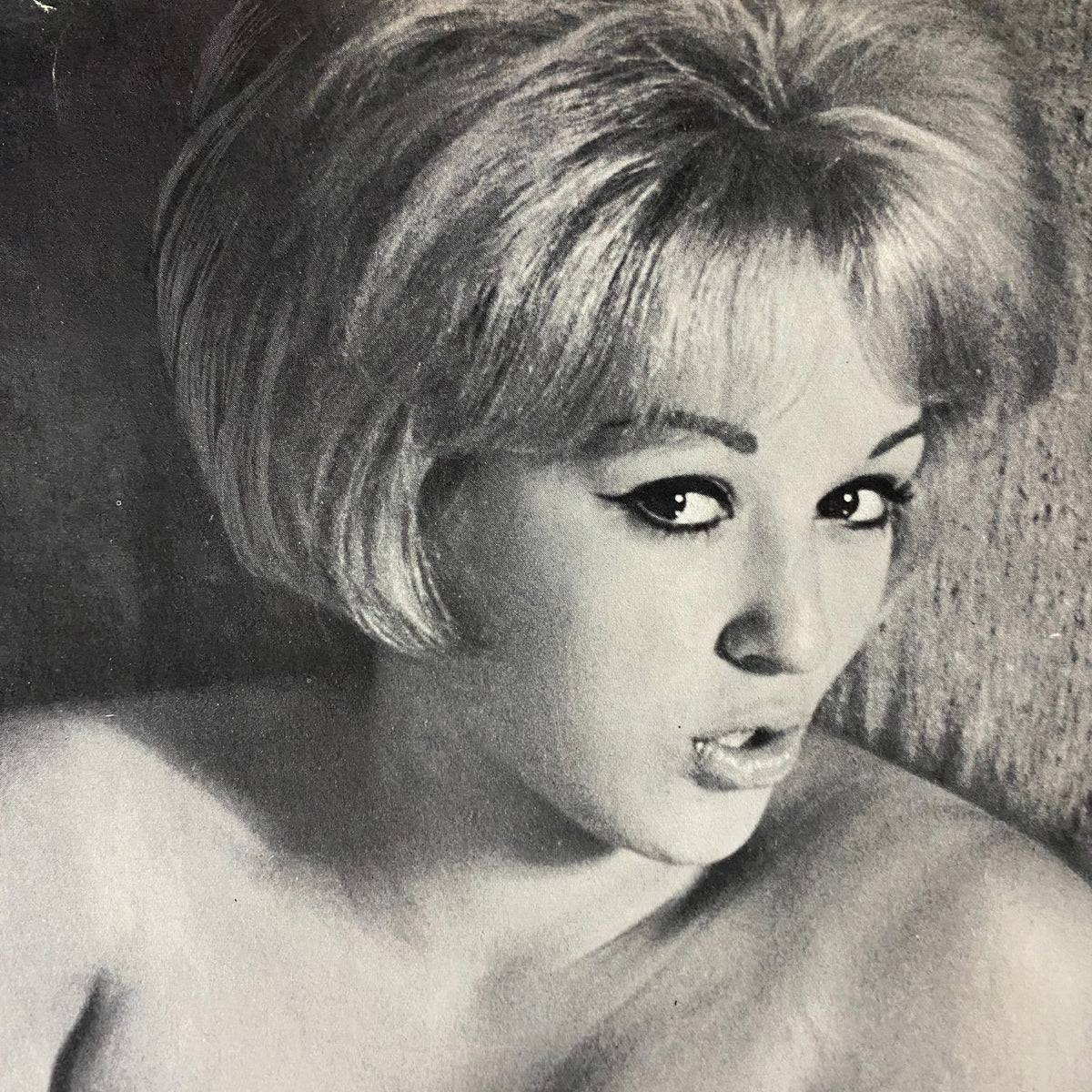 Vintage black and white photograph of a model with a classic 1960s hairstyle, featured in Adam Magazine April 1964 Vol 8 No. 4.