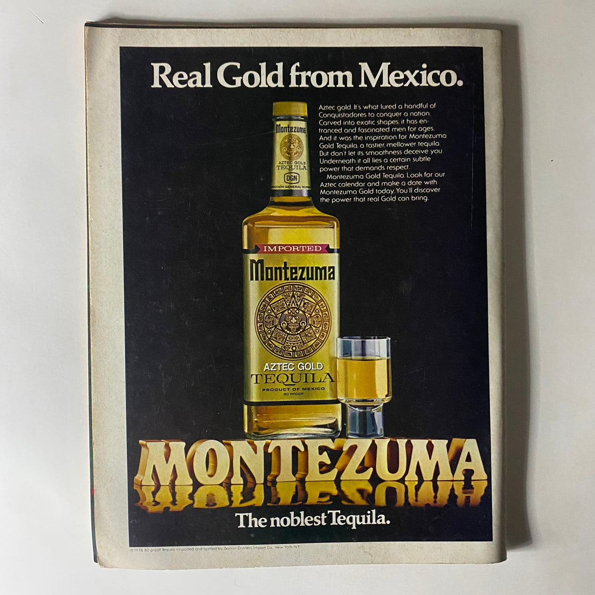 Vintage advertisement for Montezuma Aztec Gold Tequila featured in Club International Magazine June 1980. The ad highlights the luxurious appeal of the tequila with an image of the bottle and a shot glass. Text emphasizes its quality and heritage as 'The noblest Tequila.'