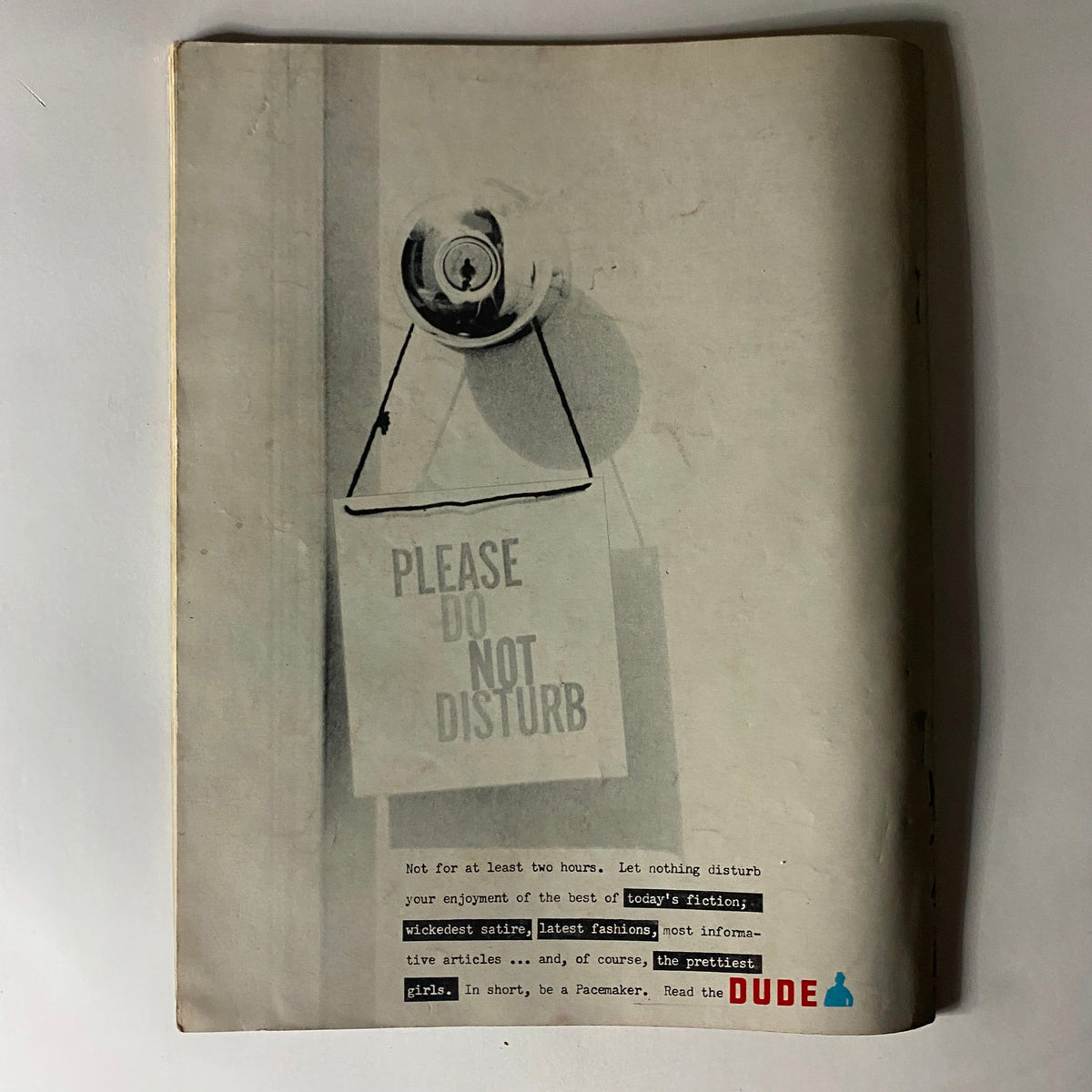Back cover of The Dude Magazine January 1961 depicting a 'Please Do Not Disturb' sign, promoting the latest fiction and articles inside.