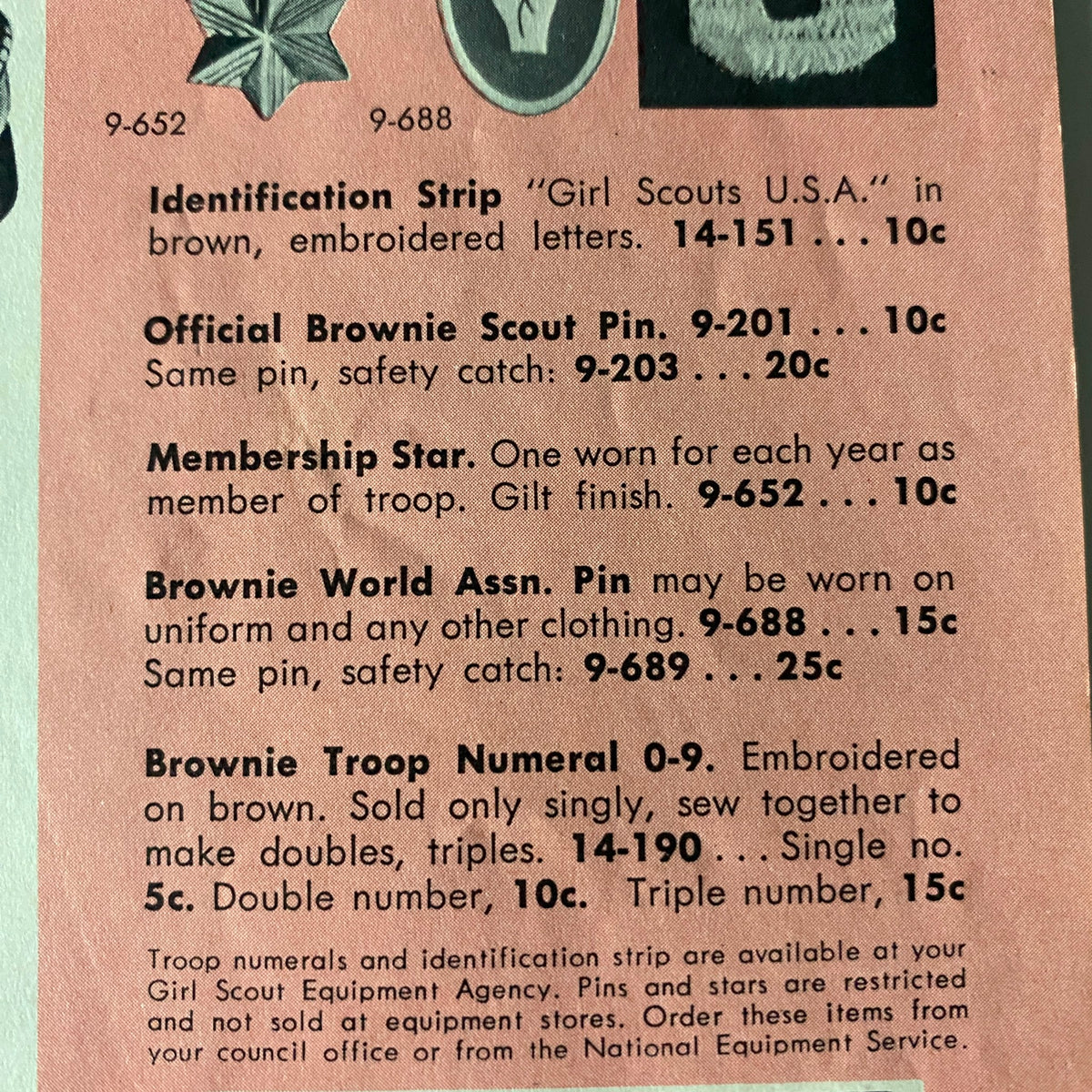 Official Brownie Scout pins and accessories featured in the "Brownie Scout Equipment Fall 1958 Spring 1959 Catalog", showcasing item details including prices and descriptions for identification strips, pins for membership, and troop numerals.