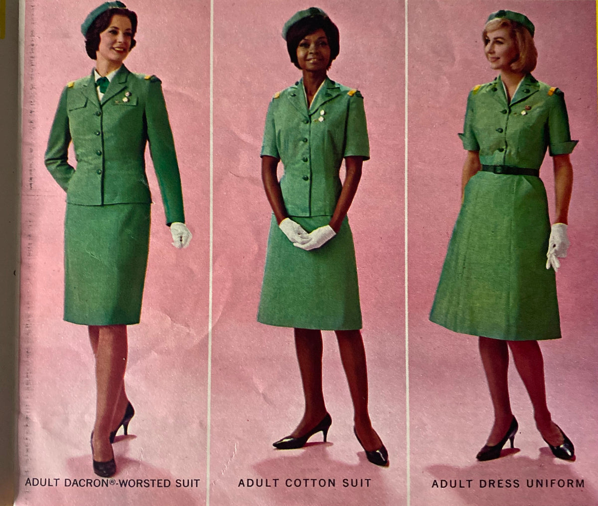 1967 Official Dress Uniforms for Girl Scouts Catalog showcasing three types of adult uniforms: Adult Dacron Worsted Suit, Adult Cotton Suit, and Adult Dress Uniform, displayed against a pink background.
