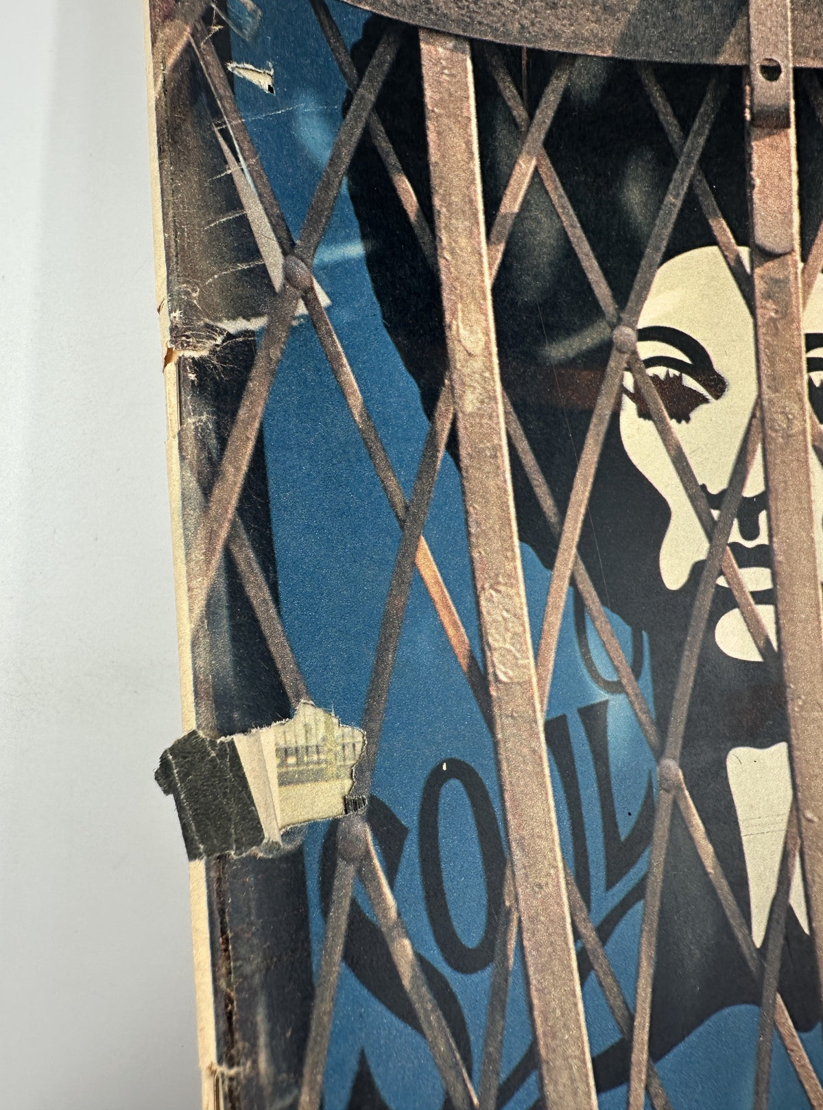 Close-up view of The New York Times Magazine cover from November 8, 1970, featuring a striking image of a woman's face partially obscured by steel grating, reflecting themes of security and crime in Harlem storefronts.