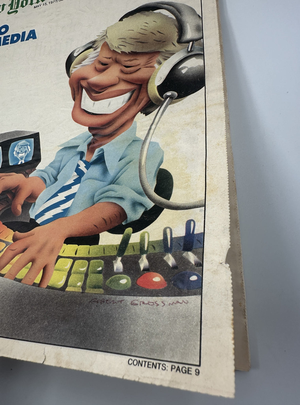 Close-up of the cover of The New York Times Magazine May 15, 1977, highlighting the playful illustration of a media figure with headphones and a colorful keyboard, signed by Robert Grossman.