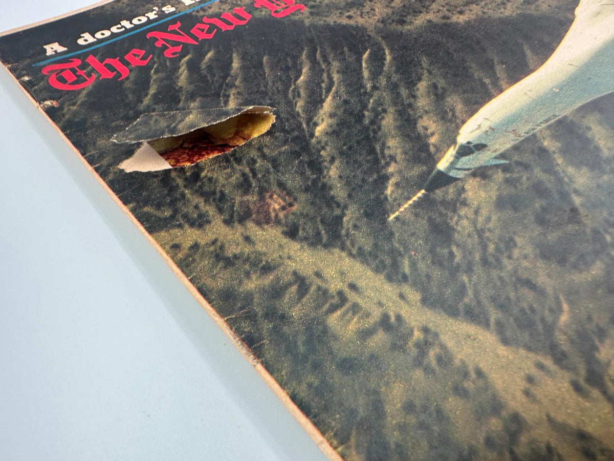 Close-up view of The New York Times Magazine July 25, 1976, featuring a B-1 Bomber cover with visible wear and a tear, showcasing the magazine's vintage condition.