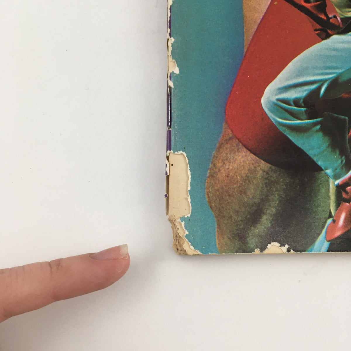 Close-up of the spine of Karate Illustrated Magazine December 1975 Vol 6 #12 showing wear and tear and the magazine's vintage appeal.