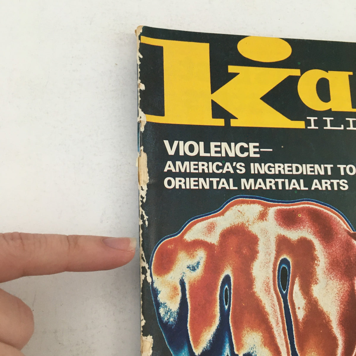 Damaged edge of Karate Illustrated Magazine September 1975 Vol 6 #9 revealing signed of wear with bold title on cover.
