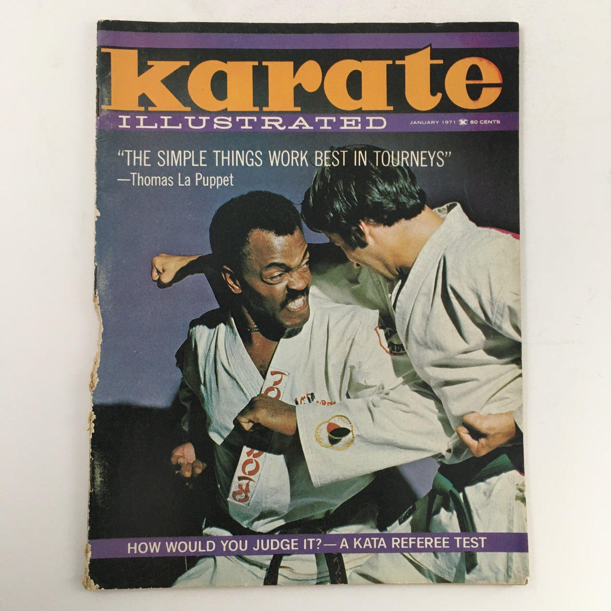 Cover of Karate Illustrated Magazine January 1971, Vol 2 #1 featuring a dynamic martial arts scene with two practitioners engaging in a tournament setting, highlighting the theme 'The Simple Things Work Best in Tournaments' by Thomas La Puppet.