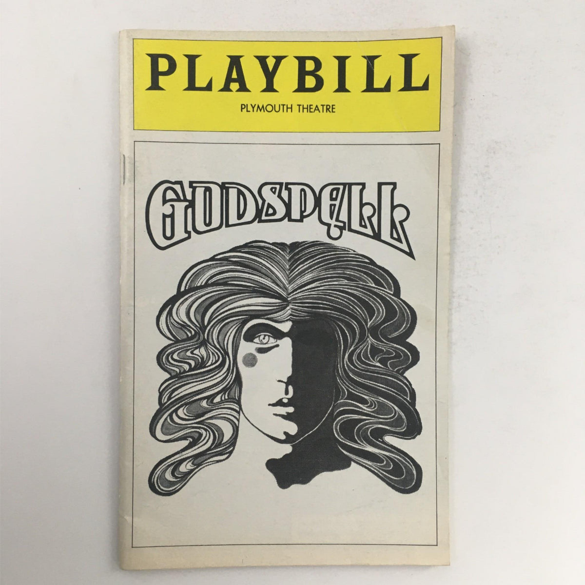 1976 Playbill for Godspell by Stephen Schwartz at Plymouth Theatre featuring distinctive cover art of a stylized figure with flowing hair, representing the theatrical production.