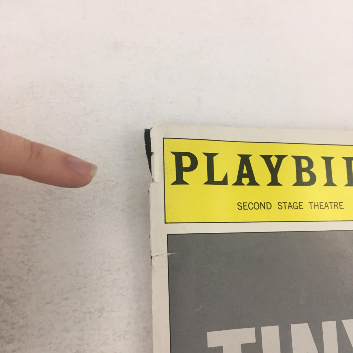 Close-up of the corner of the 2000 Playbill for 'Tiny Alice' by Edward Albee, presented at Second Stage Theatre, showing minor wear and the distinctive yellow header.