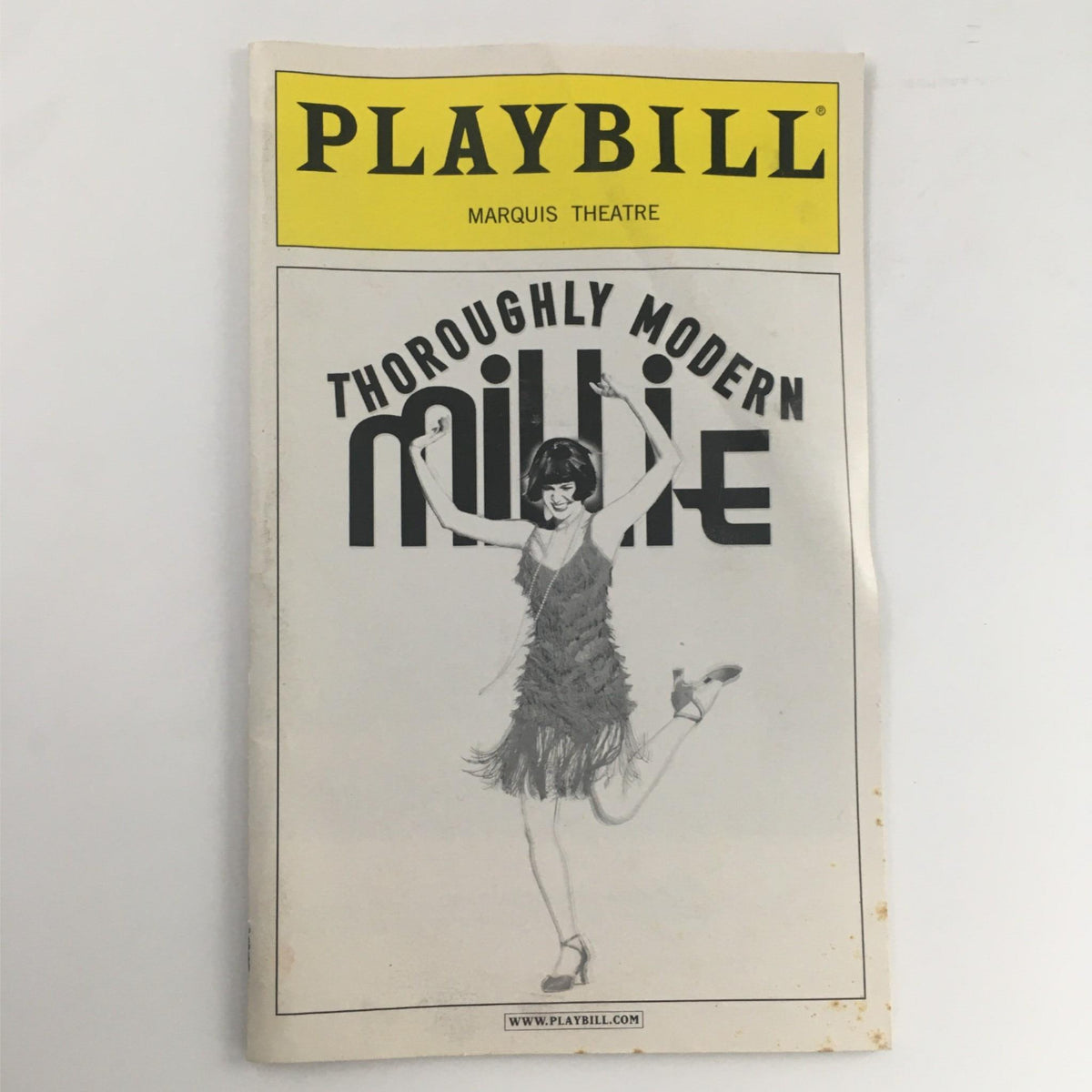 2003 Playbill for Thoroughly Modern Millie by Richard Morris Sick Scanlan at Marquis Theatre, featuring the iconic cover design with a dancer in a vibrant, flapper-style outfit.