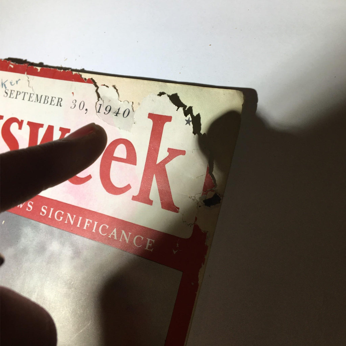 Detail view of the Newsweek Magazine September 30, 1940, cover showing the date and title. The magazine presents signs of wear, emphasizing its vintage status and historical significance.