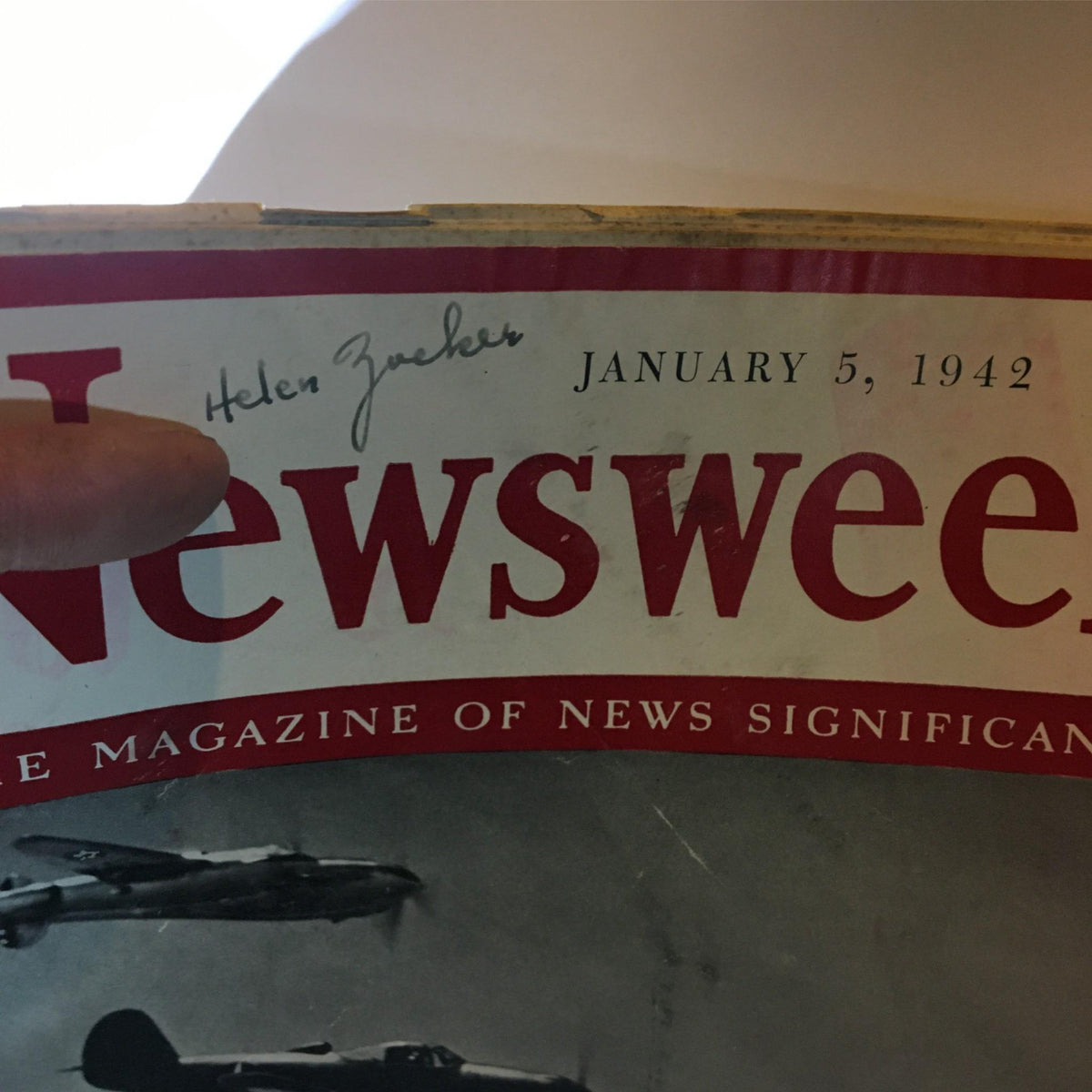 Close-up view of the cover of Newsweek Magazine, January 5, 1942, showing the title and a signature, highlighting its historic value and vintage condition.