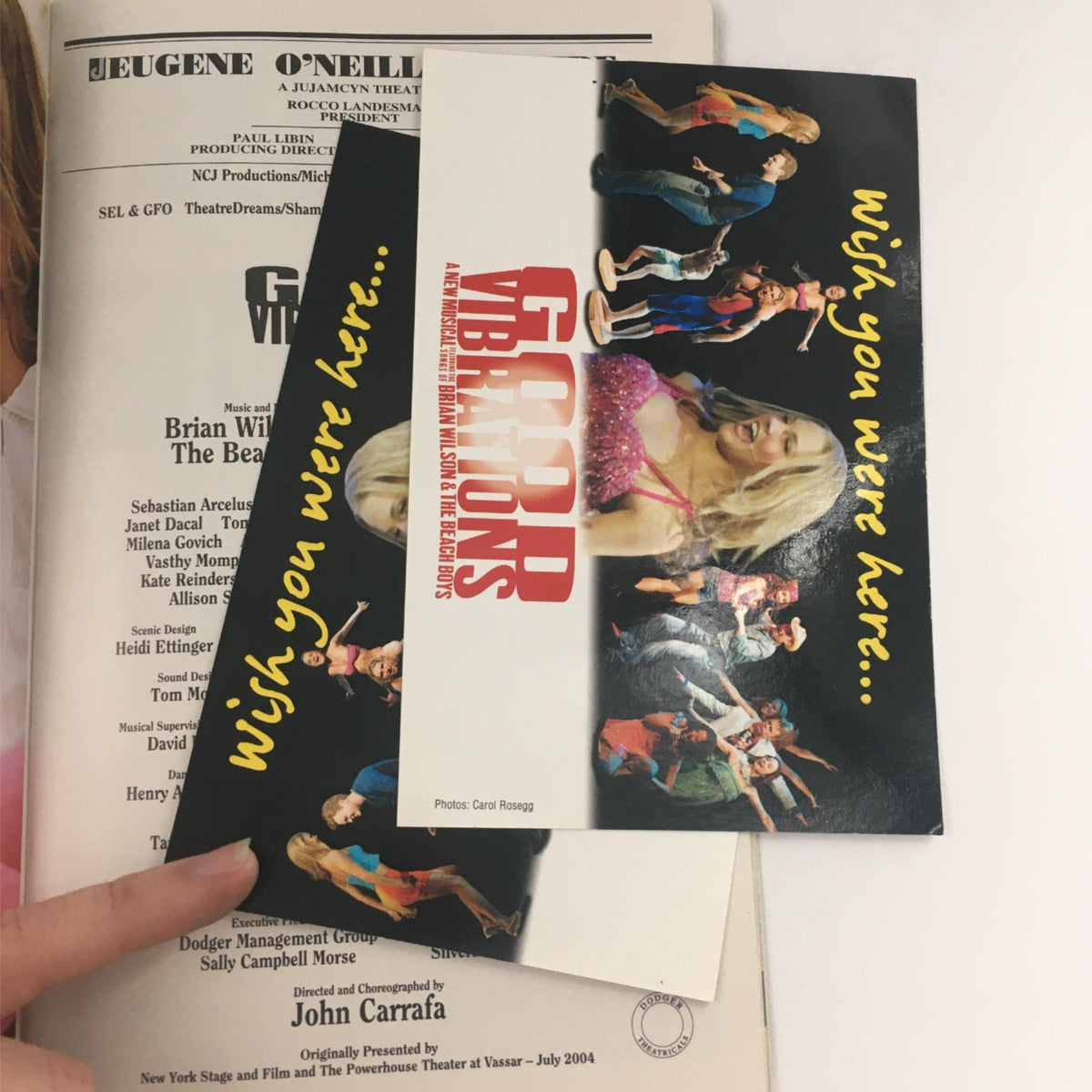 Promotional materials from the 2005 Playbill for Good Vibrations, including a card that says 'wish you were here' alongside visuals of the musical cast.