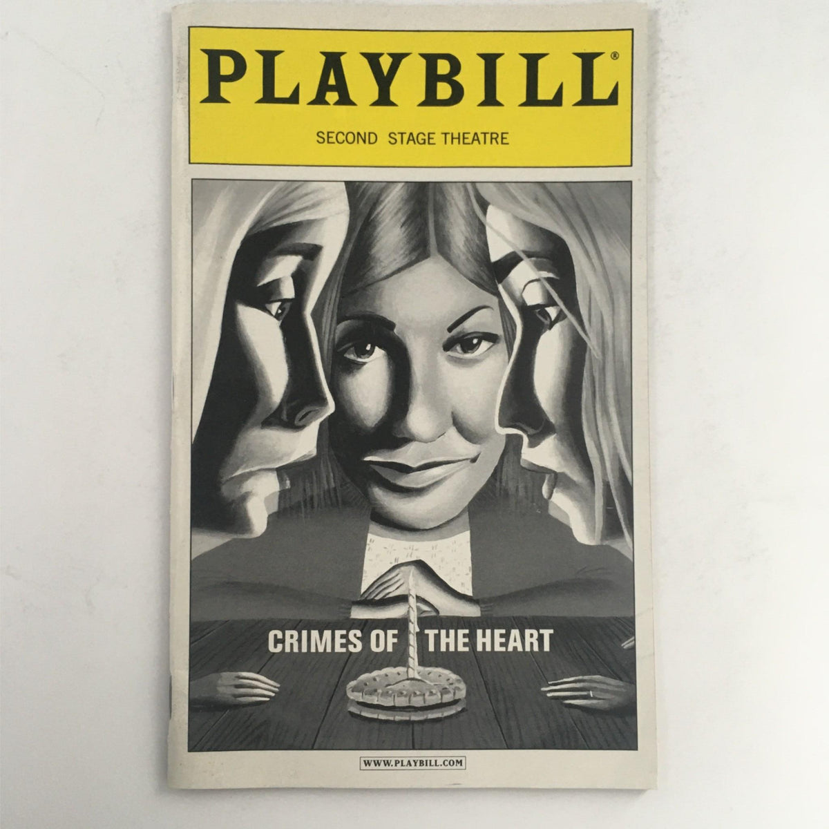 2001 Playbill for Crimes of the Heart featuring artwork of a woman among two faces, highlighting the themes of the play.