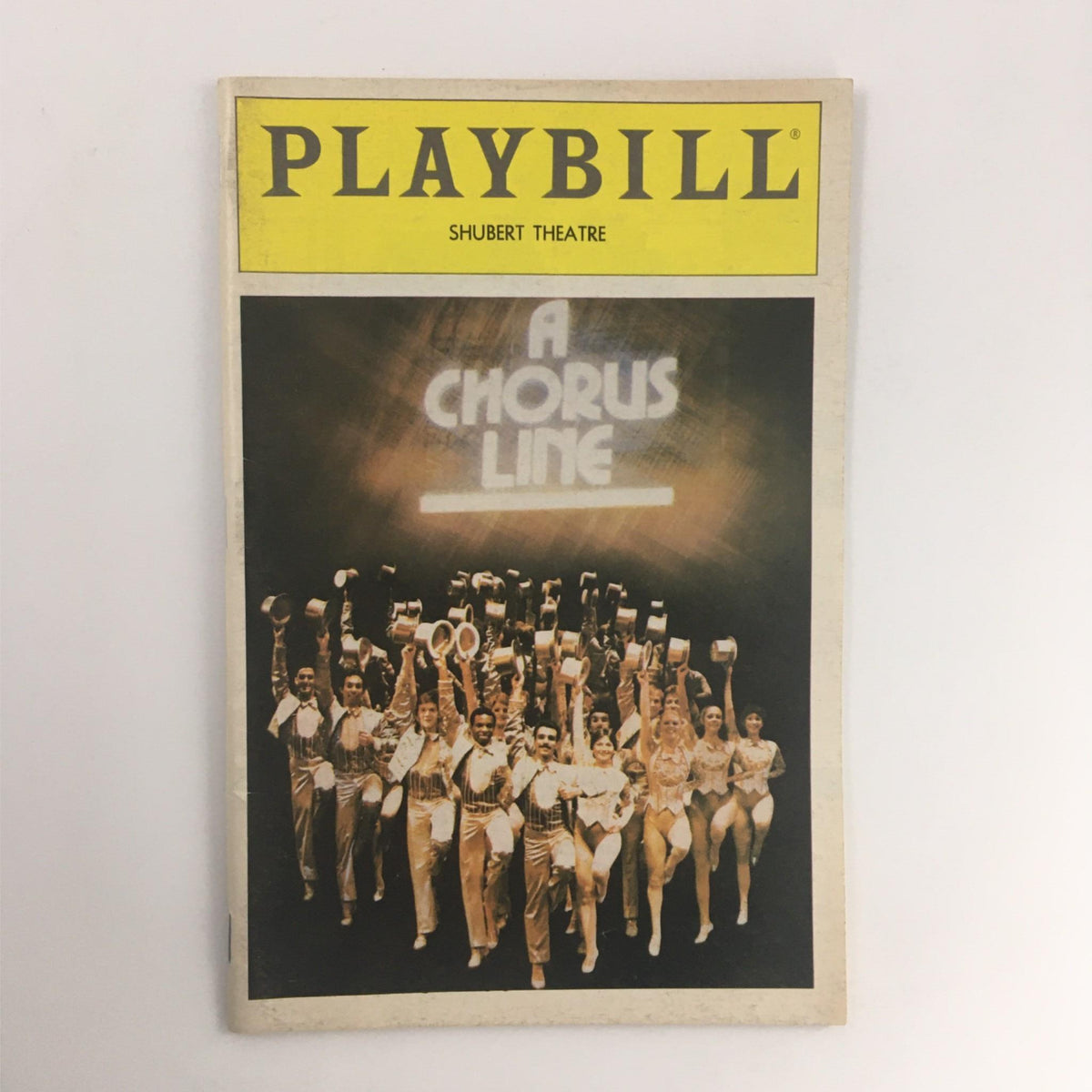 1984 Playbill for A Chorus Line by Michael Bennett and Bernard Gersten, featured at the Shubert Theatre, showcasing the vibrant cast performance with iconic choreography.