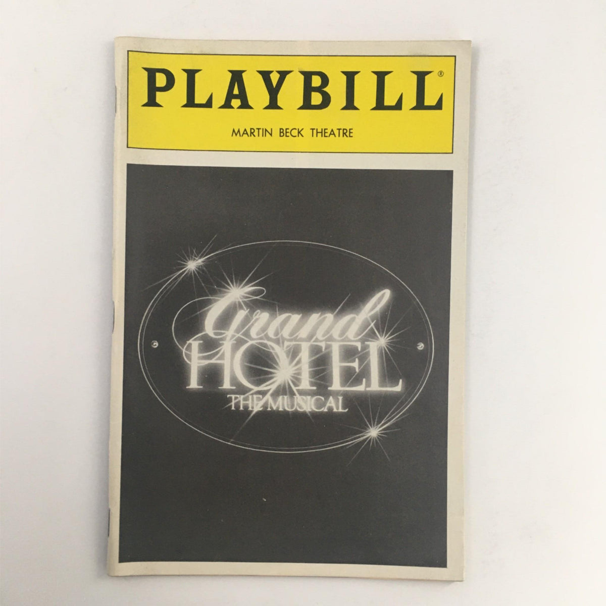 1990 Playbill for Grand Hotel: The Musical at Martin Beck Theatre showcasing the cover design with glittering text and classic Broadway style.