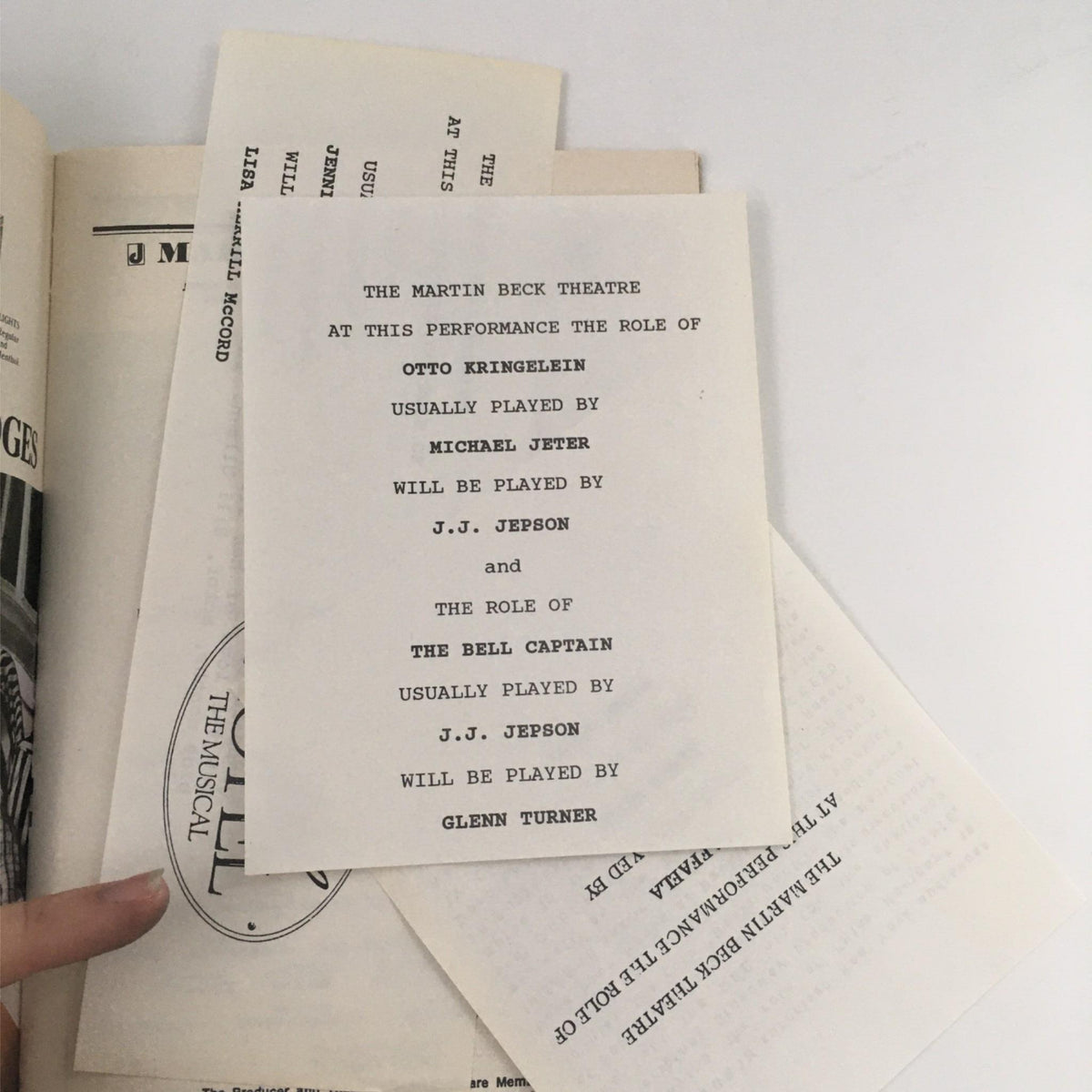 Insert from the 1990 Playbill for Grand Hotel: The Musical detailing performance role assignments for Otto Kringelein and the Bell Captain, enhancing the collectible's historical value.