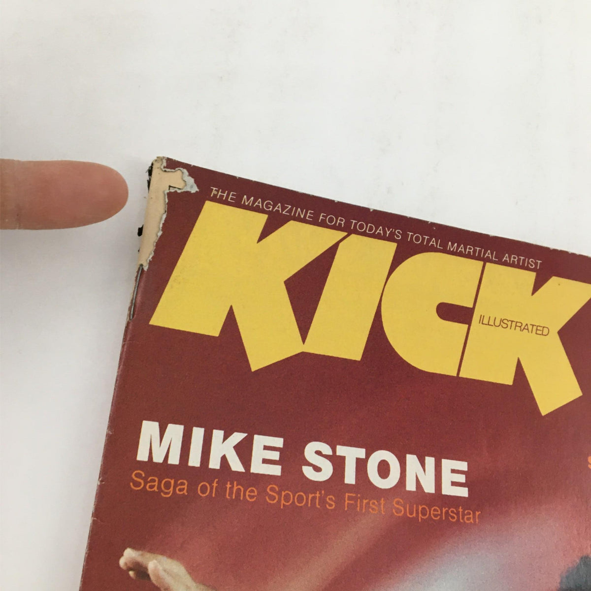 Close-up of the cover of Kick Illustrated Magazine December 1980 featuring Mike Stone, showcasing wear and tear typical of vintage collectibles.