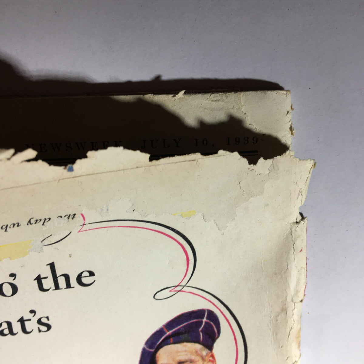 Close-up of the top corner of Newsweek Magazine dated July 10, 1939, showing vintage wear and the magazine's title, highlighting its collectible value as a historical artifact.