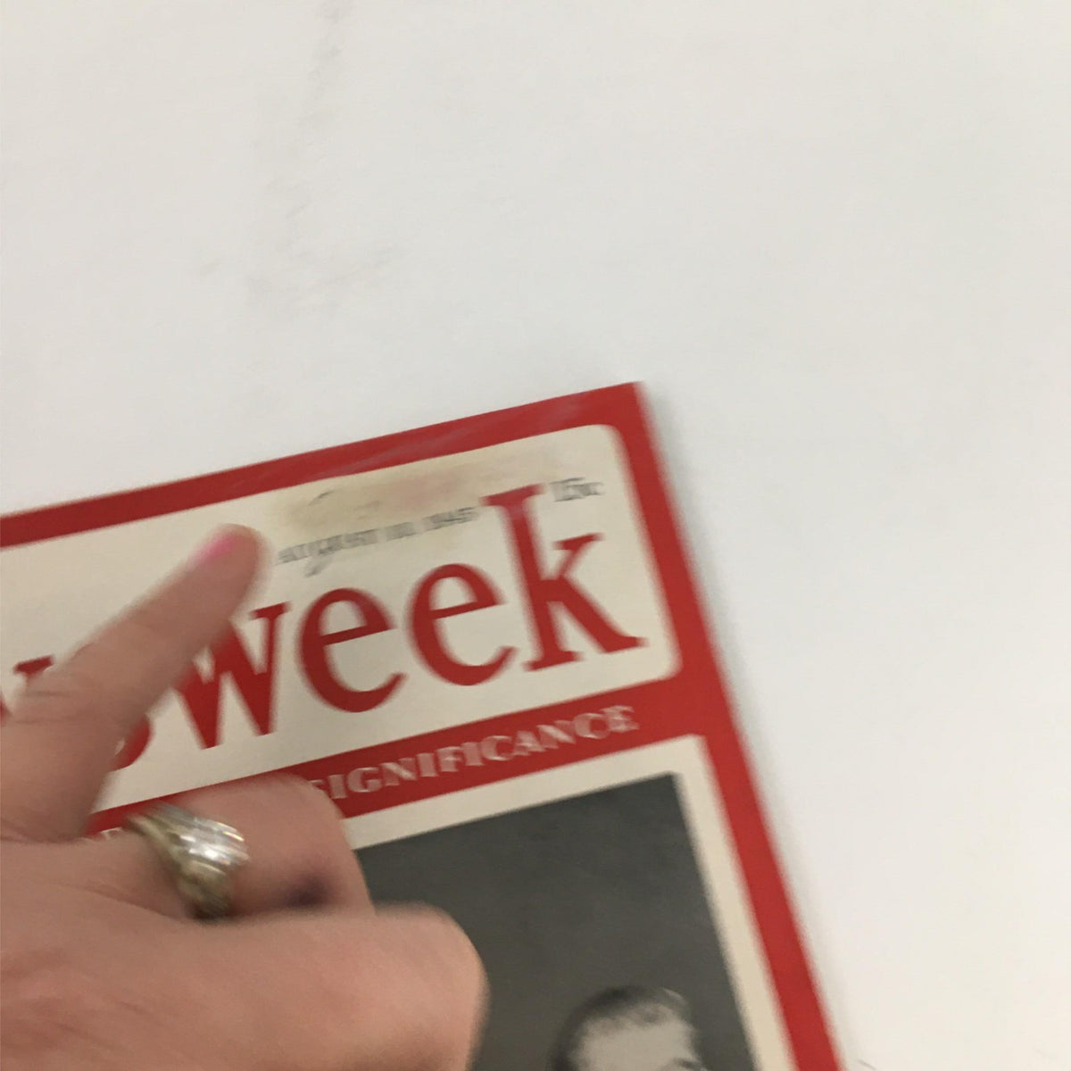 Close-up of the Newsweek Magazine cover from August 13, 1945, showing the title 'Verdict of the Three: Germany Must Atone' with a finger pointing at the date on the magazine.