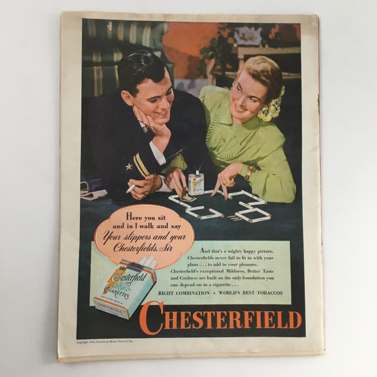 Vintage magazine advertisement featuring a smiling couple, promoting Chesterfield cigarettes, from Newsweek Magazine February 5, 1945: The Volkssturmer - Hitler's Last Man.