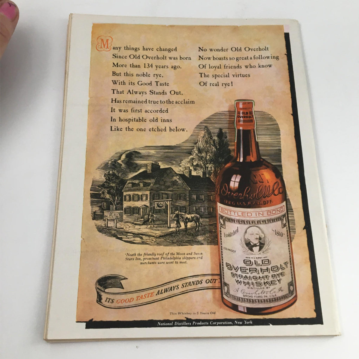 Back cover of Newsweek Magazine June 12, 1944 displaying an advertisement for Old Overholt whiskey, showcasing vintage style illustrations.