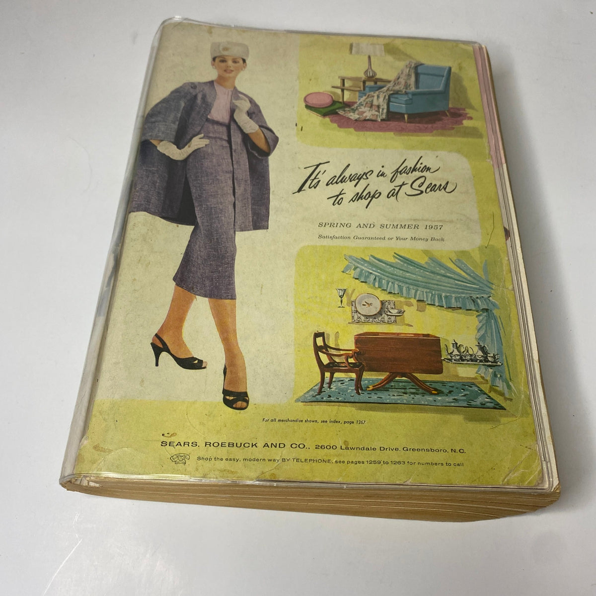 Cover of the 1957 Sears Spring and Summer Catalog featuring a stylish woman in vintage attire with decor elements, emphasizing fashion and home goods.