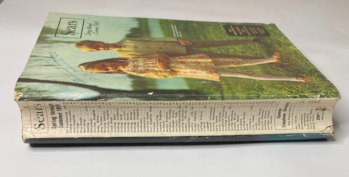 Side view of the 1969 Sears Spring Through Summer Catalog, displaying the iconic cover illustration of children in retro apparel.