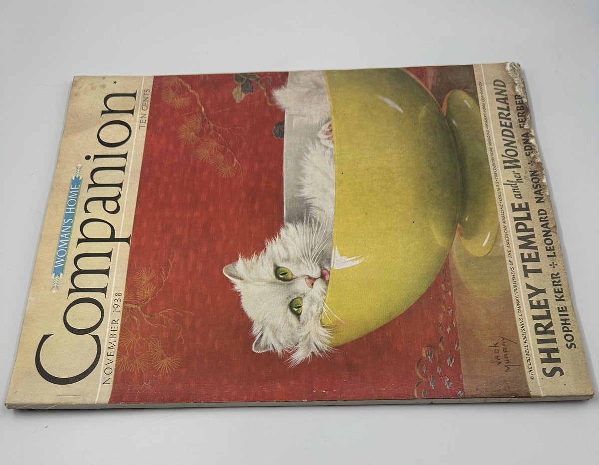 Close-up view of the November 1938 issue of Woman’s Home Companion Magazine, showcasing a charming cat illustration and the title 'Shirley Temple and her Wonderland'.