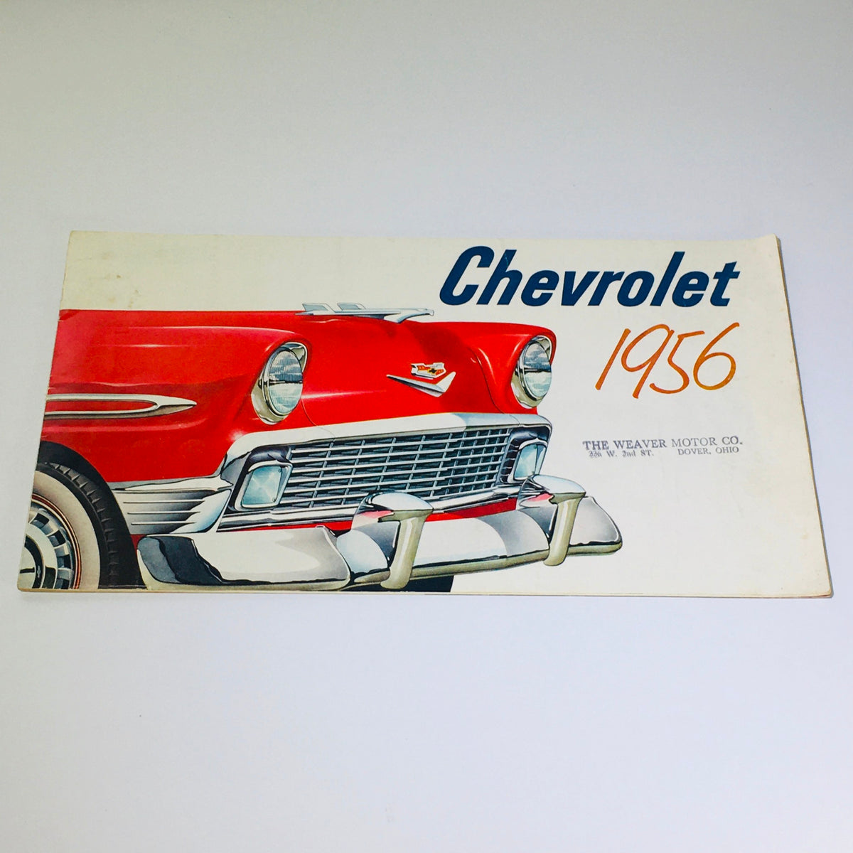 Vintage 1956 Chevrolet car brochure cover showcasing a classic red Chevy with a detailed illustration, part of a 24-page catalog from The Weaver Motor Co.