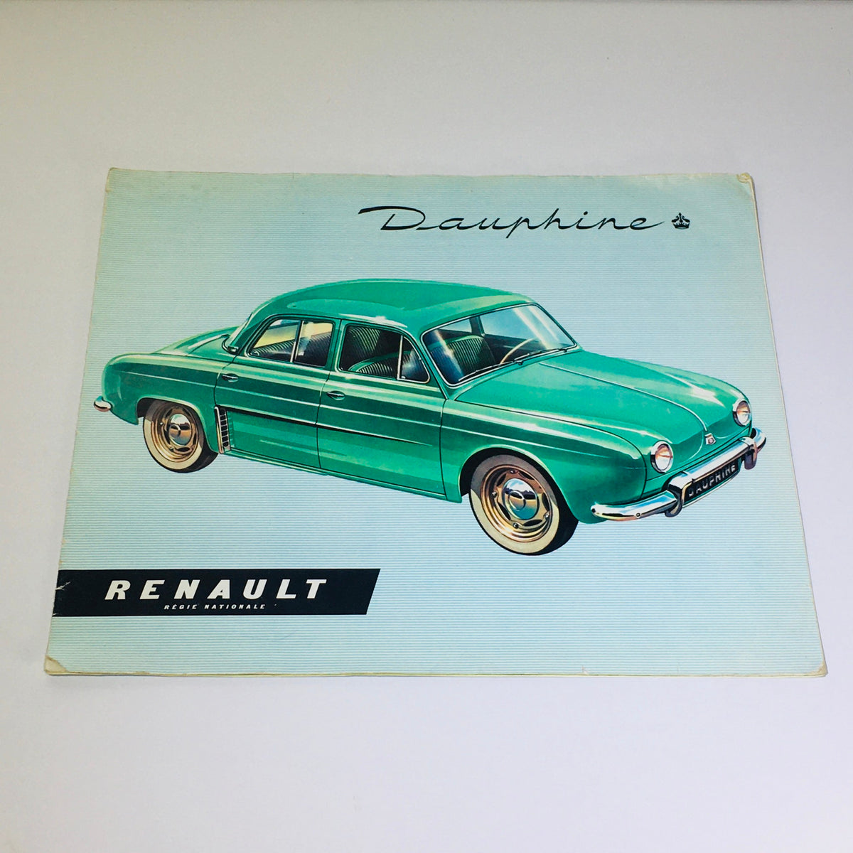Vintage 1956 Renault Dauphine 4-Speed MT car brochure cover showcasing a classic green Renault Dauphine illustration.