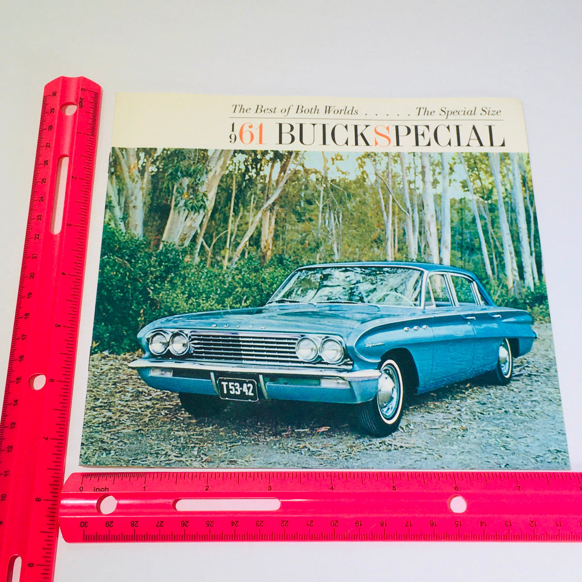 Front cover of the Vintage 1961 Buick Special Deluxe Sedan Station Wagon catalog brochure featuring a classic Buick car parked amongst trees.